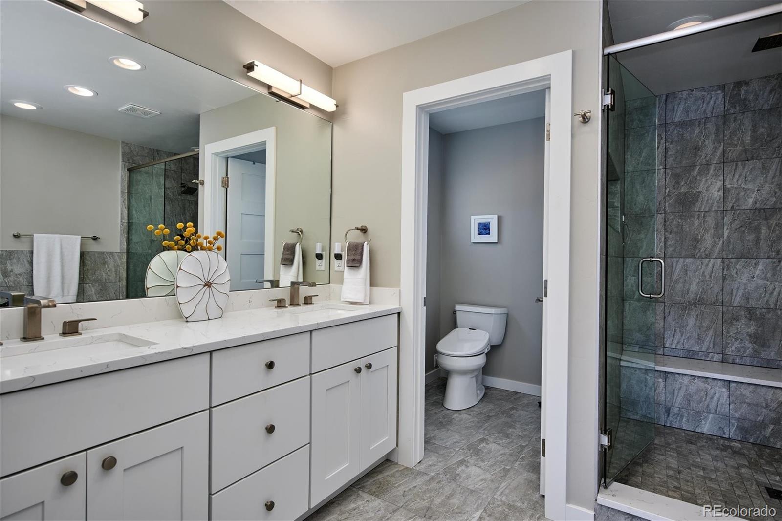 4583 Utica Street Denver, CO 80212 - Photo 18 of 40 a bathroom with a granite countertop sink mirror and toilet