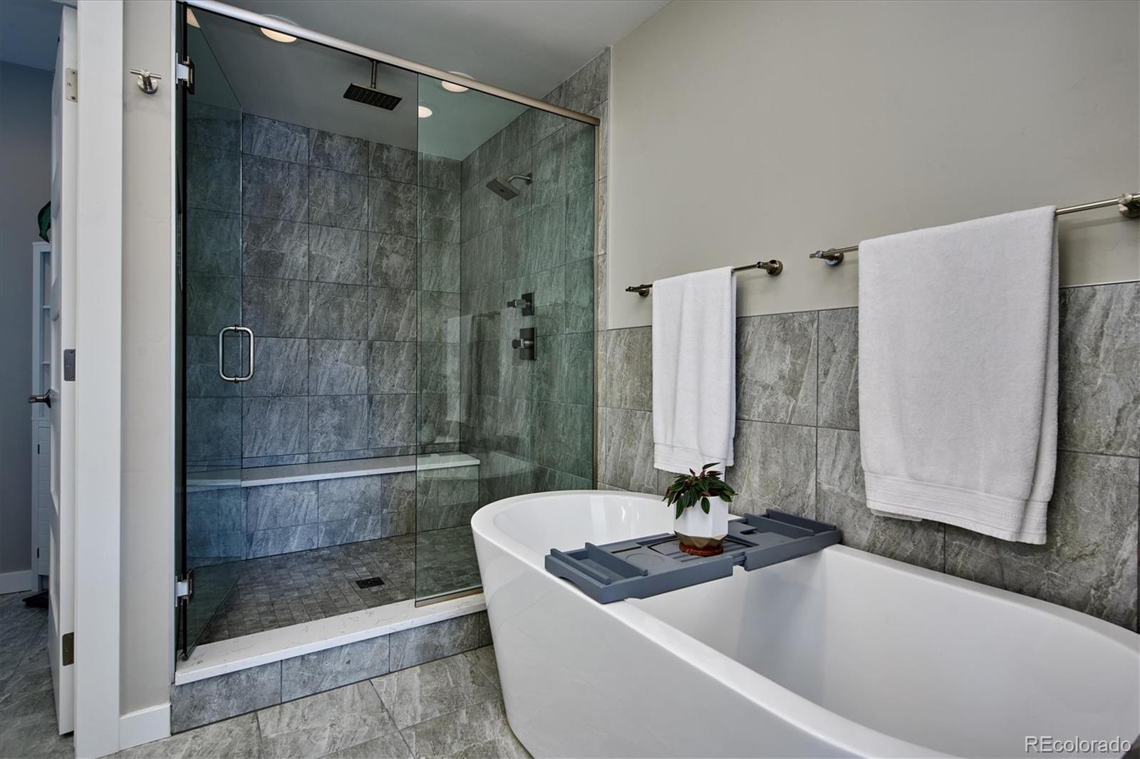 4583 Utica Street Denver, CO 80212 - Photo 19 of 40 a bathroom with a bathtub and a shower