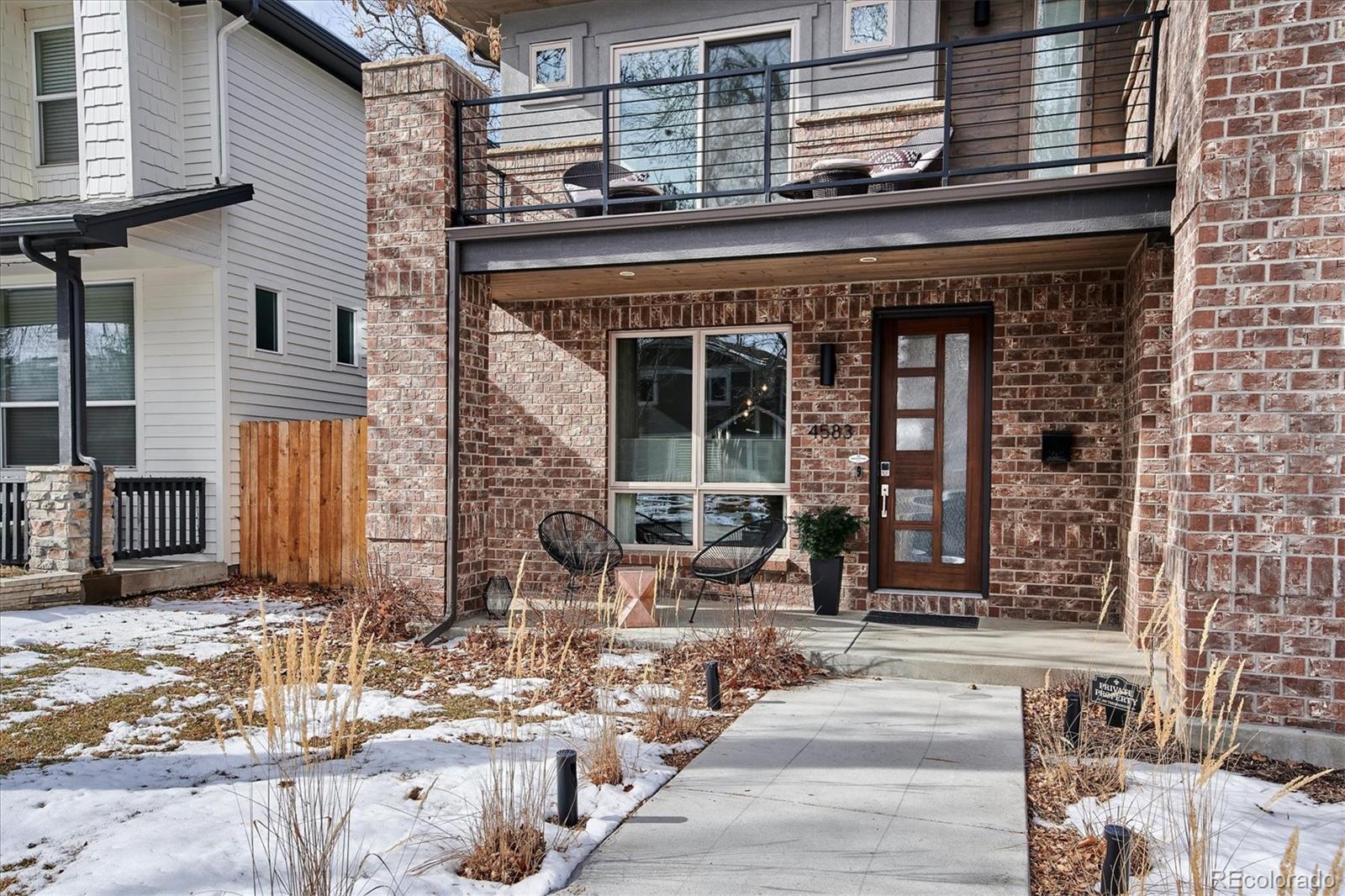 4583 Utica Street Denver, CO 80212 - Photo 2 of 40 a front view of a building with glass windows