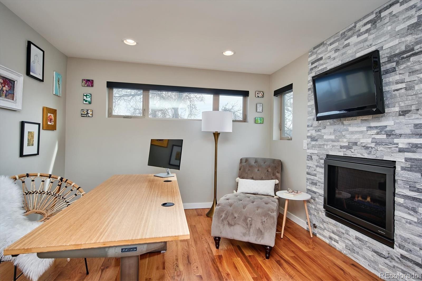 4583 Utica Street Denver, CO 80212 - Photo 25 of 40 a living room with furniture fireplace and flat screen tv