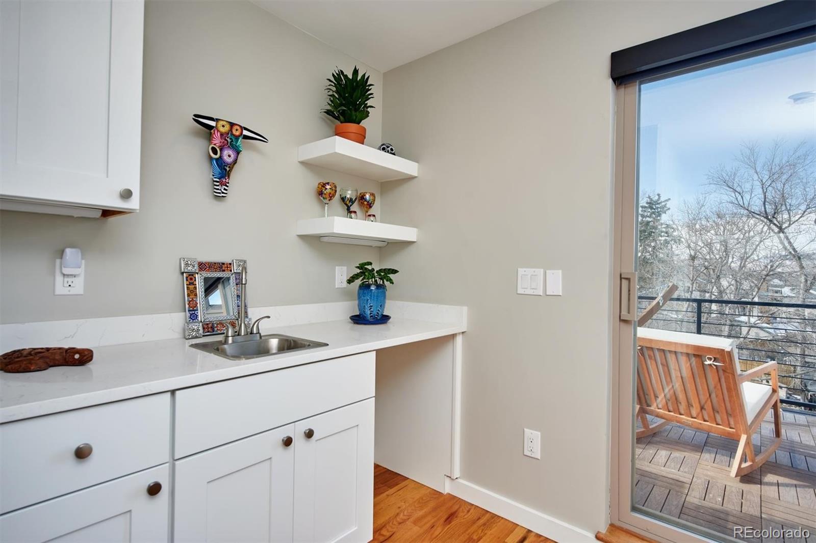 4583 Utica Street Denver, CO 80212 - Photo 27 of 40 a kitchen with cabinets and window