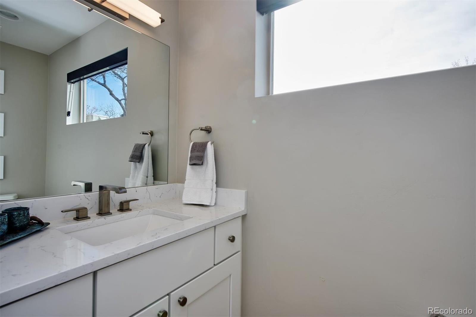4583 Utica Street Denver, CO 80212 - Photo 29 of 40 a bathroom with a sink and a mirror