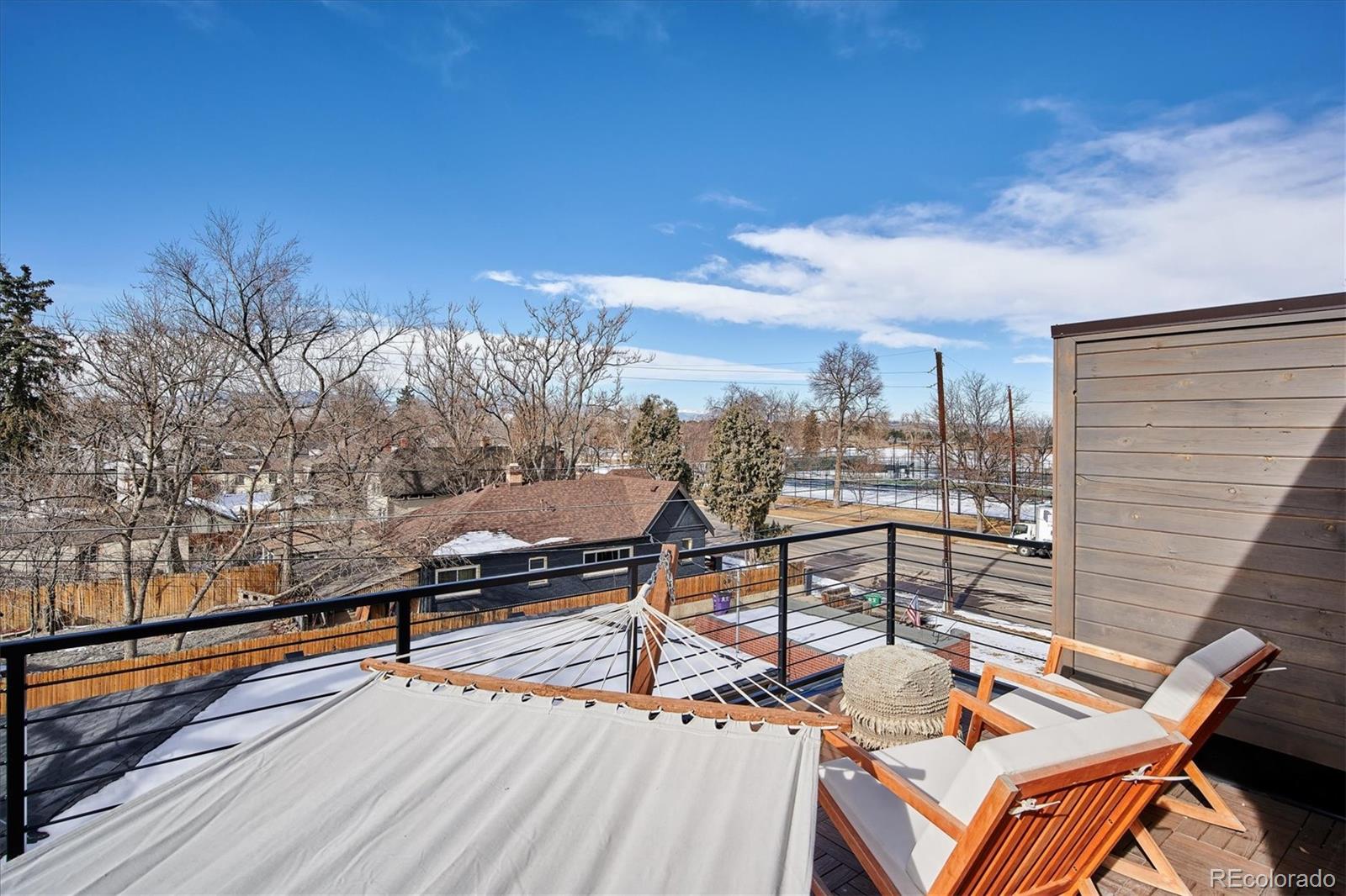 4583 Utica Street Denver, CO 80212 - Photo 30 of 40 a view of a terrace with wooden benches