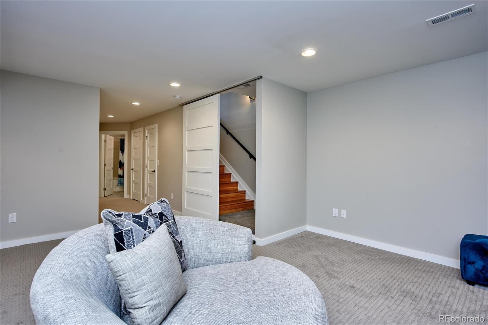 4583 Utica Street Denver, CO 80212 - Photo 32 of 40 a living room with furniture and a ceiling fan