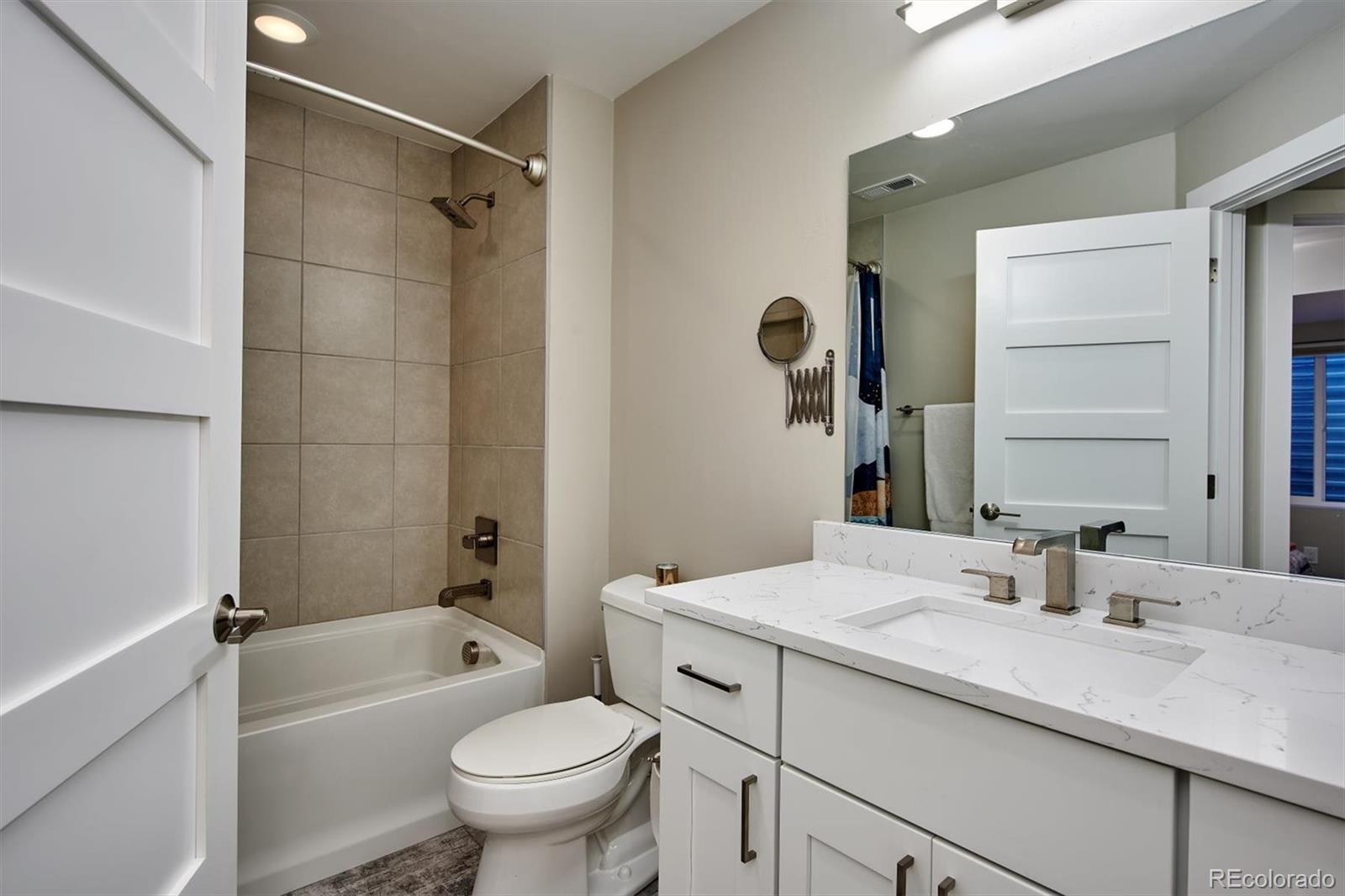 4583 Utica Street Denver, CO 80212 - Photo 34 of 40 a bathroom with a sink a toilet and shower