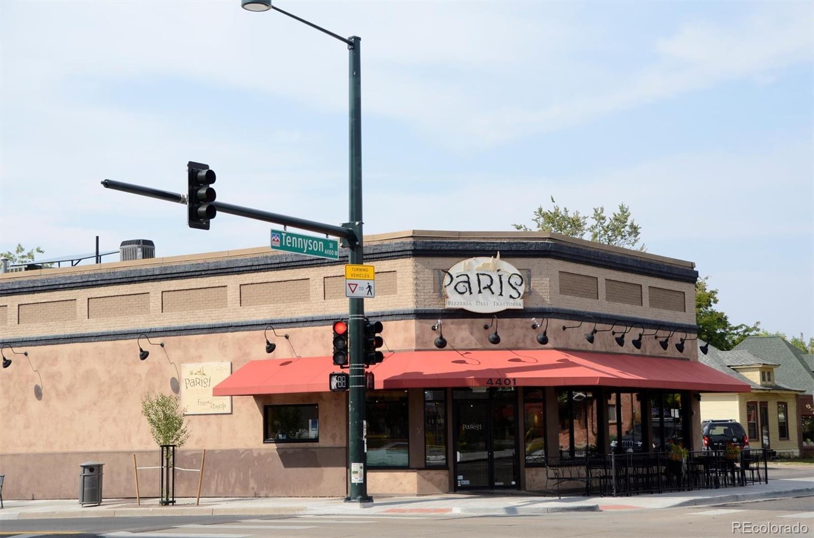 4583 Utica Street Denver, CO 80212 - Photo 39 of 40 a man walking down a street next to a building