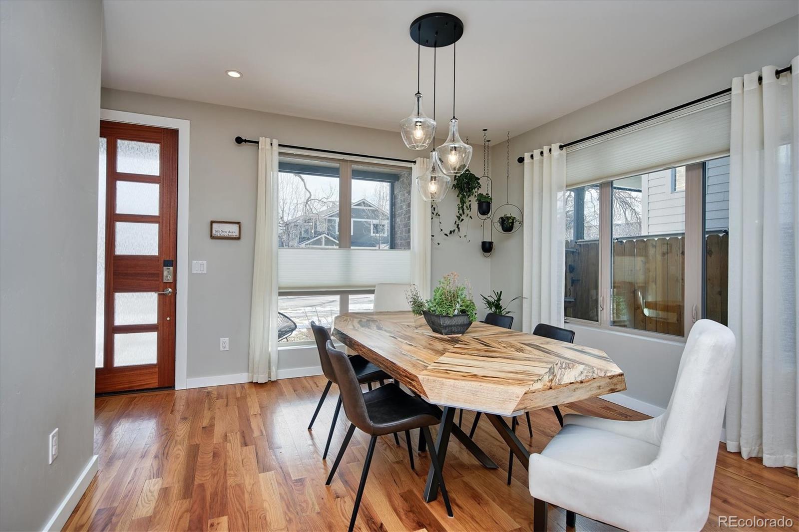 4583 Utica Street Denver, CO 80212 - Photo 5 of 40 a view of a dining room with furniture window and wooden floor