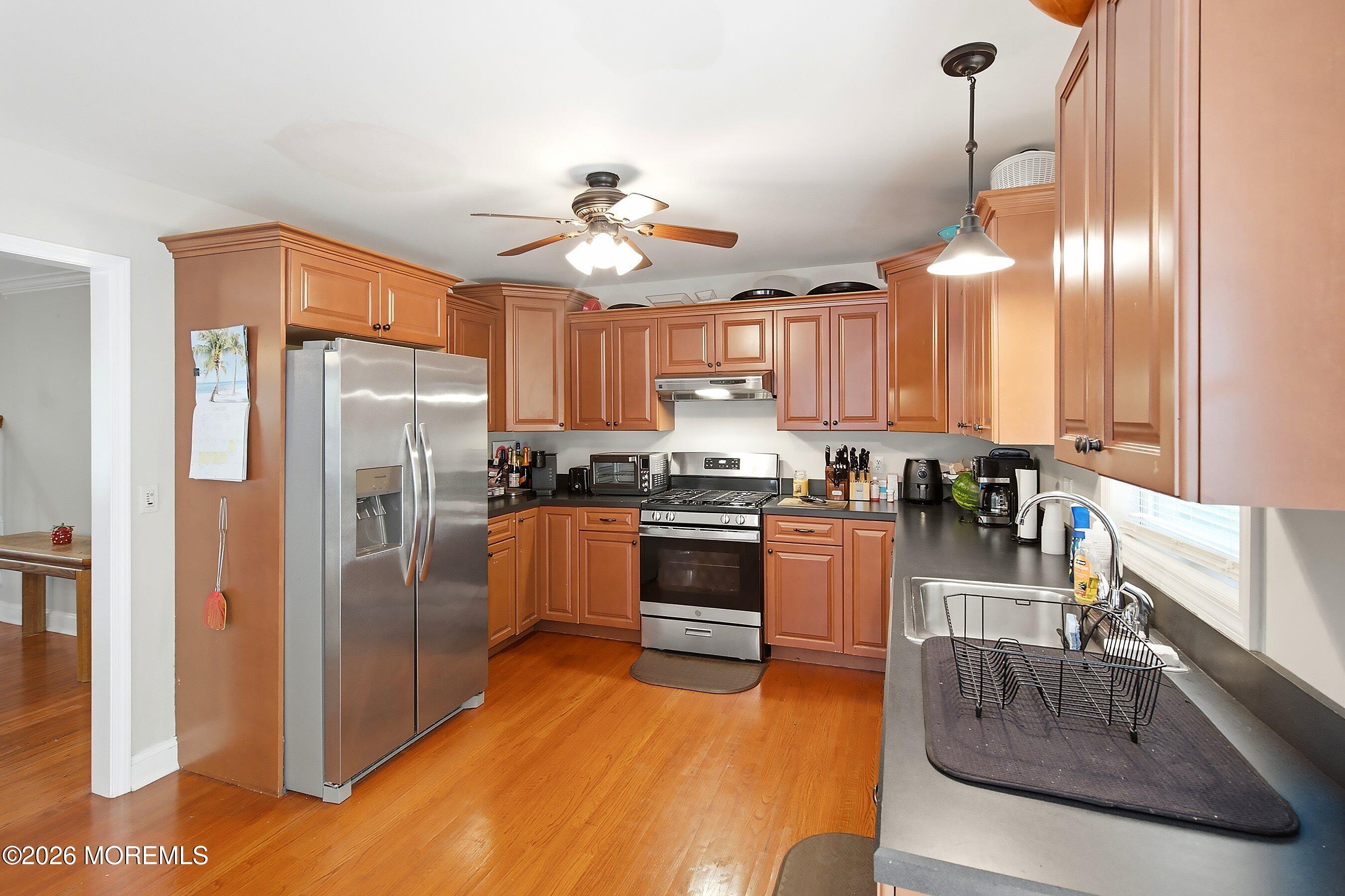 935 Bethel Church Road Jackson, NJ 08527 - Photo 12 of 32 a kitchen with kitchen island granite countertop a refrigerator a sink a stove and island