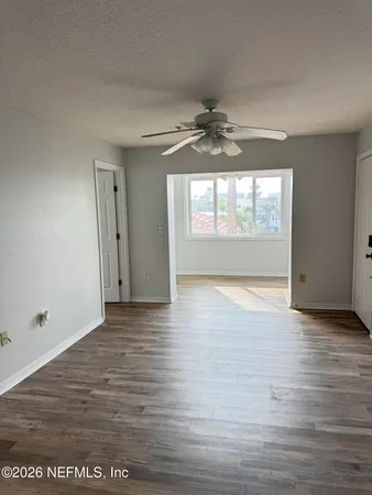 wooden floor in an empty room with a window
