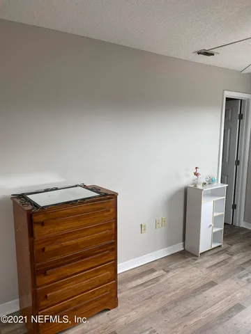 a view of walk in closet with wooden floor
