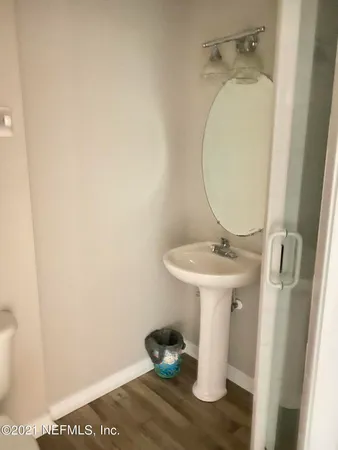 a bathroom with a sink a toilet and mirror