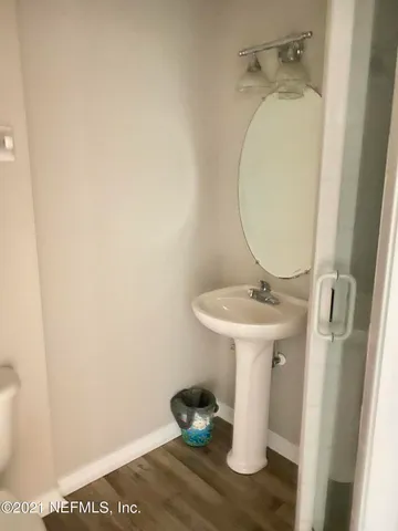 a bathroom with a sink a toilet and mirror