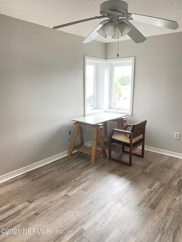 a workspace with chandelier fan and window
