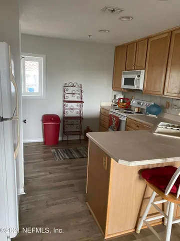 a kitchen with a stove refrigerator and sink