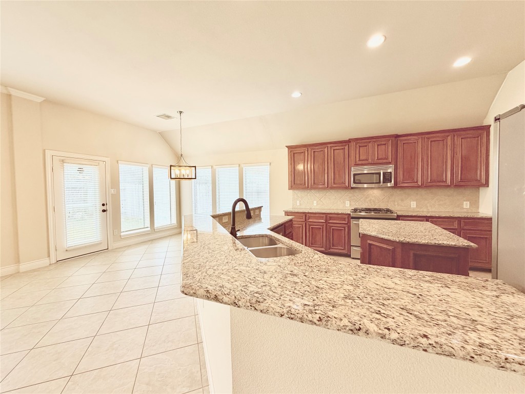 22015 Rustic Canyon Lane Richmond, TX 77469 - Photo 11 of 26 a kitchen with stainless steel appliances granite countertop a sink and cabinets