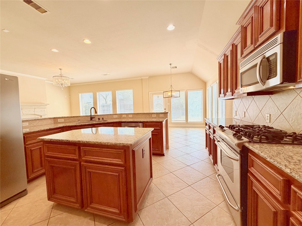 22015 Rustic Canyon Lane Richmond, TX 77469 - Photo 12 of 26 a kitchen with stainless steel appliances granite countertop a stove and a sink