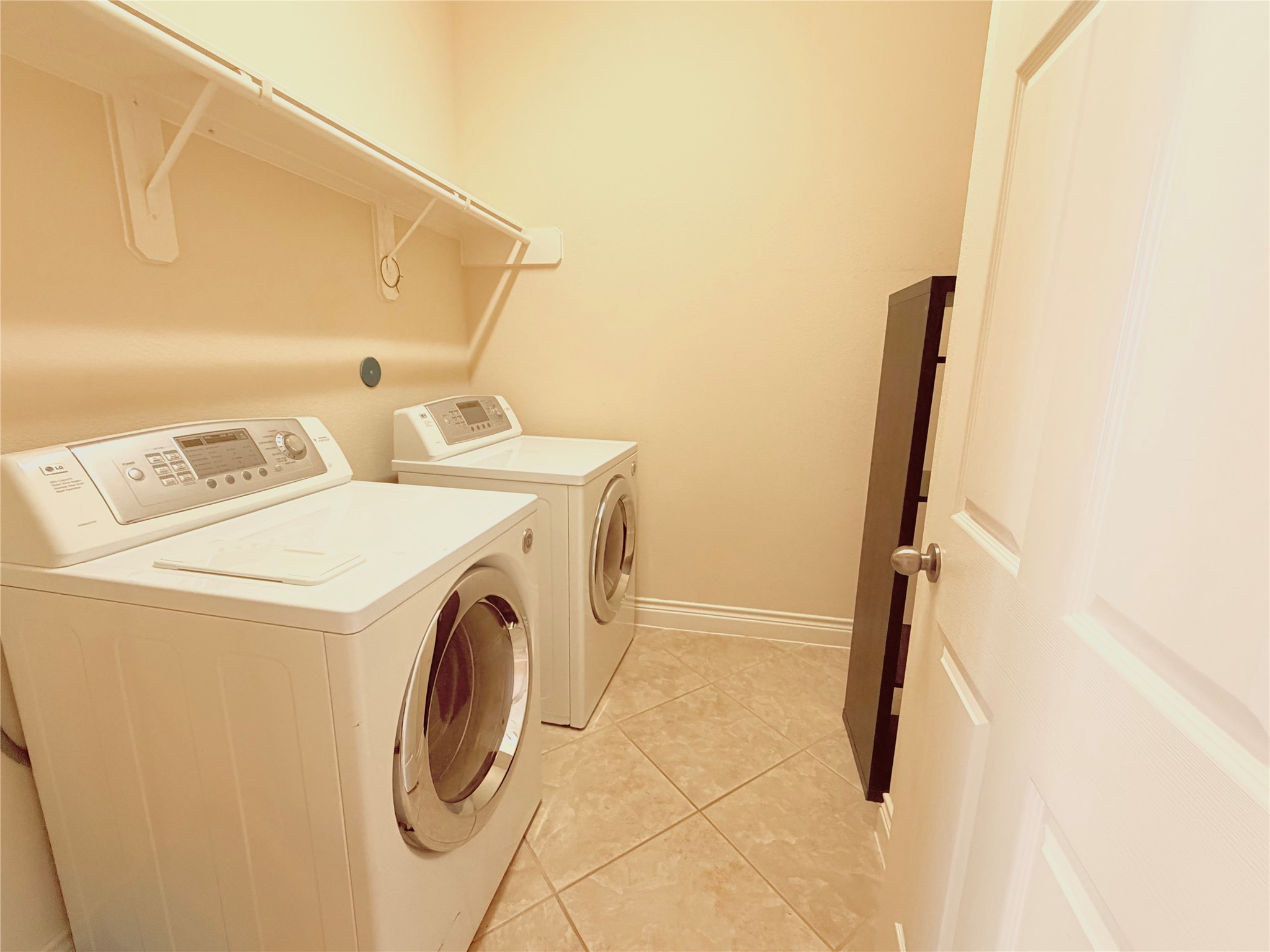 22015 Rustic Canyon Lane Richmond, TX 77469 - Photo 14 of 26 a utility room with dryer and washer
