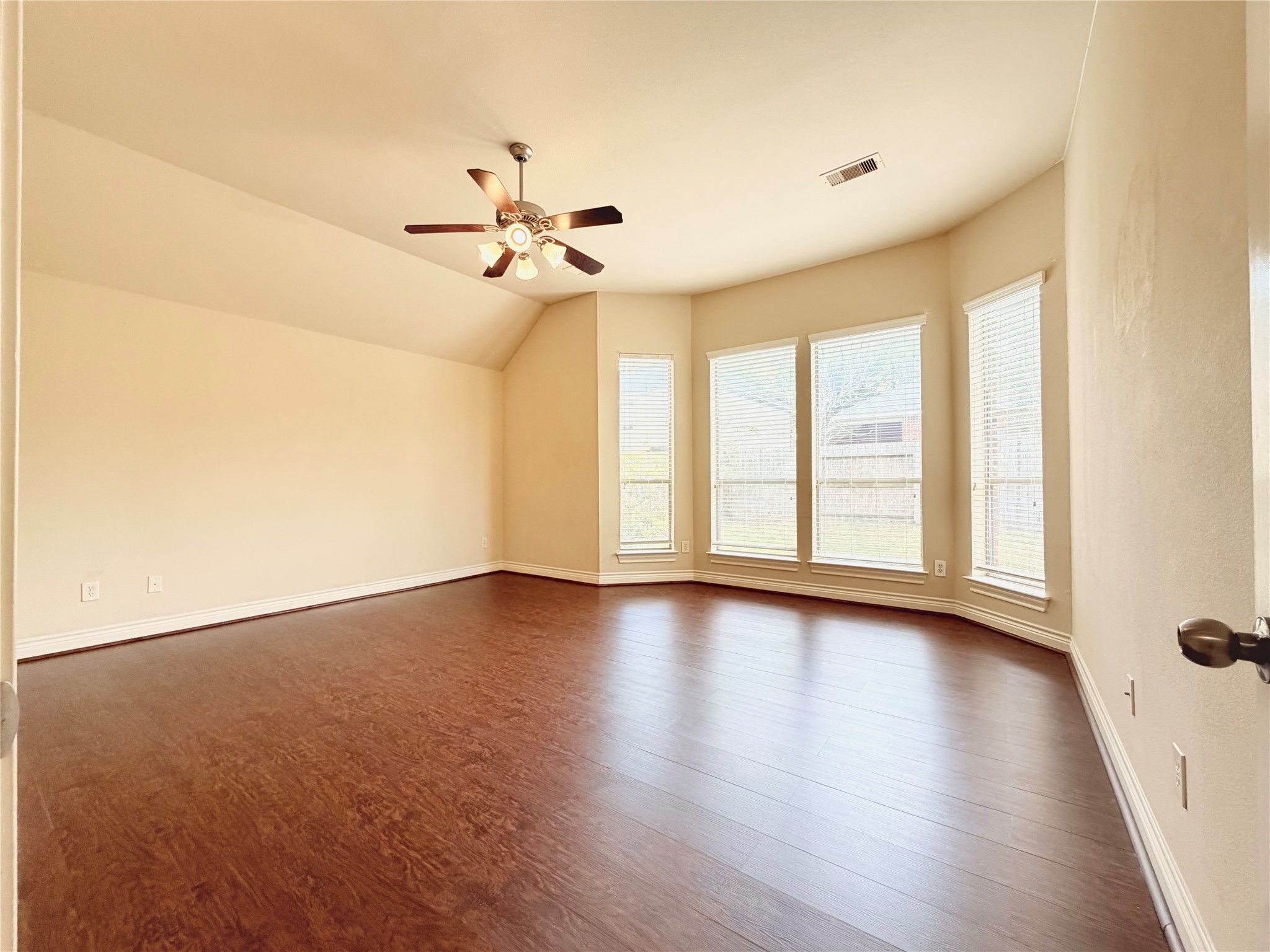 22015 Rustic Canyon Lane Richmond, TX 77469 - Photo 16 of 26 an empty room with wooden floor fan and windows