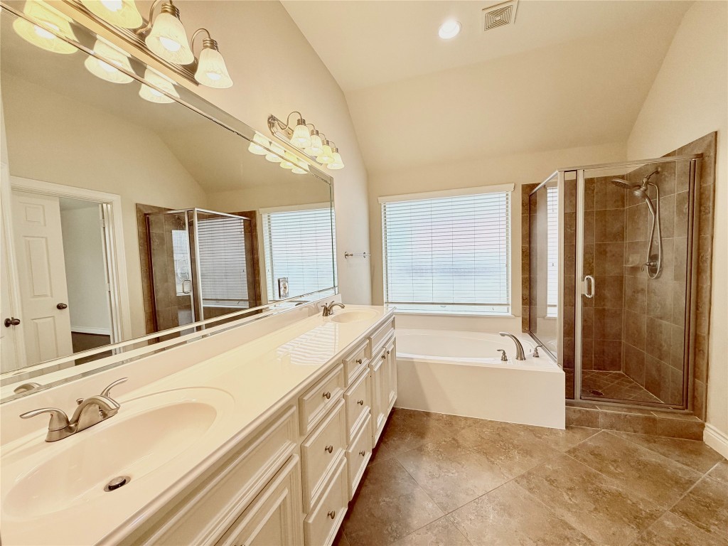 22015 Rustic Canyon Lane Richmond, TX 77469 - Photo 19 of 26 a spacious bathroom with a tub sink and mirror