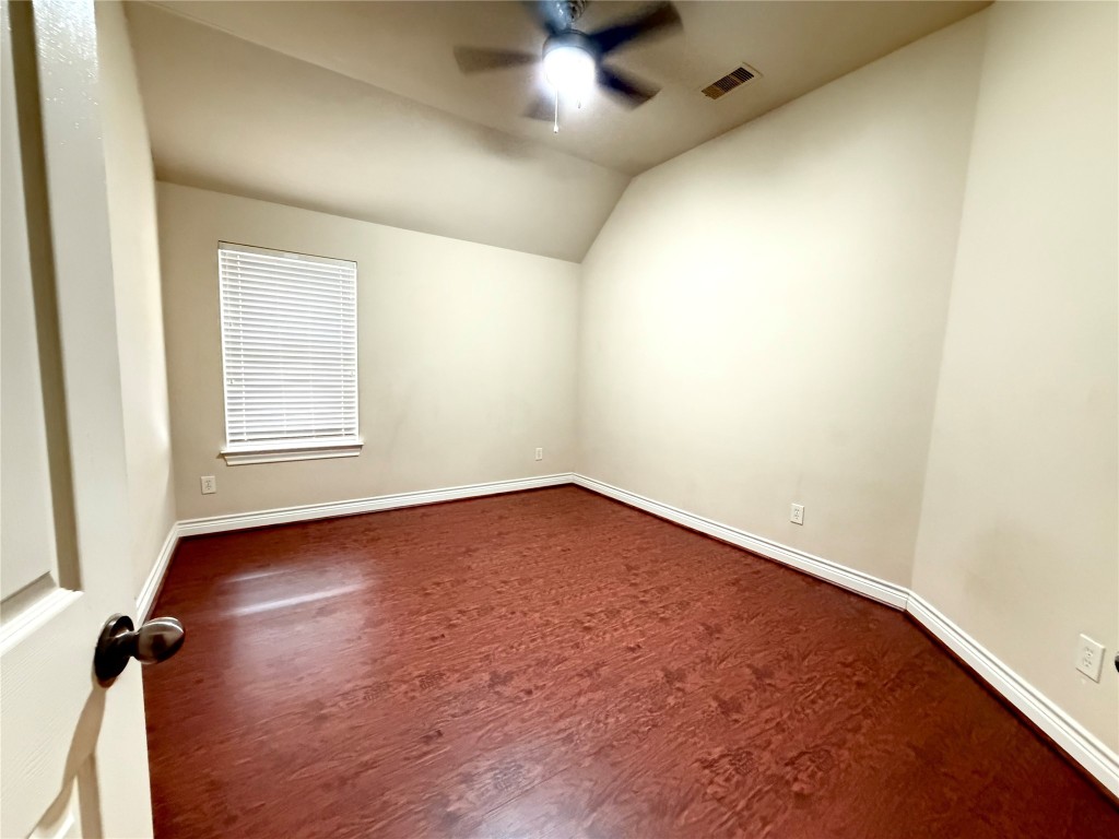 22015 Rustic Canyon Lane Richmond, TX 77469 - Photo 20 of 26 an empty room with wooden floor and windows