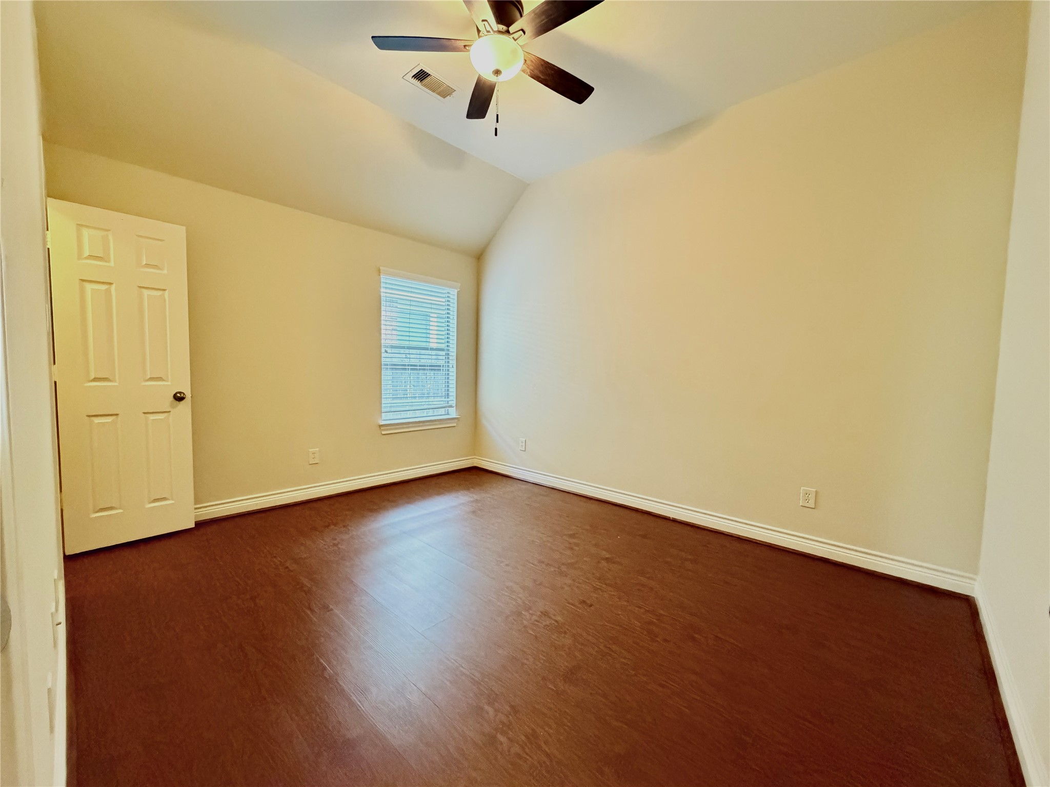 22015 Rustic Canyon Lane Richmond, TX 77469 - Photo 22 of 26 a view of an empty room with wooden floor and a ceiling fan
