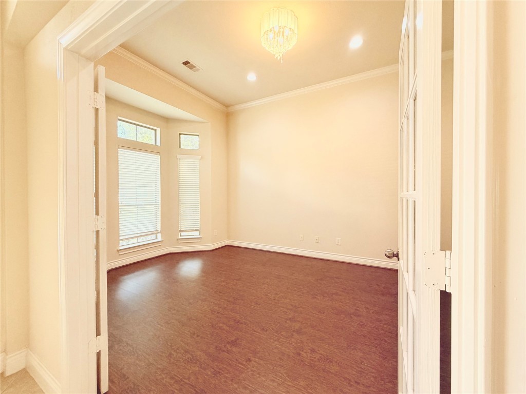 22015 Rustic Canyon Lane Richmond, TX 77469 - Photo 4 of 26 a view of an empty room with wooden floor and a window