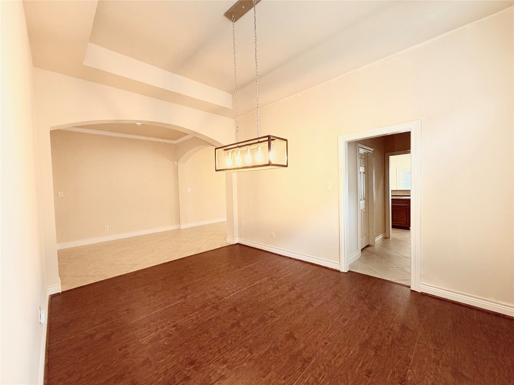 22015 Rustic Canyon Lane Richmond, TX 77469 - Photo 7 of 26 a view of an empty room with wooden floor and a window
