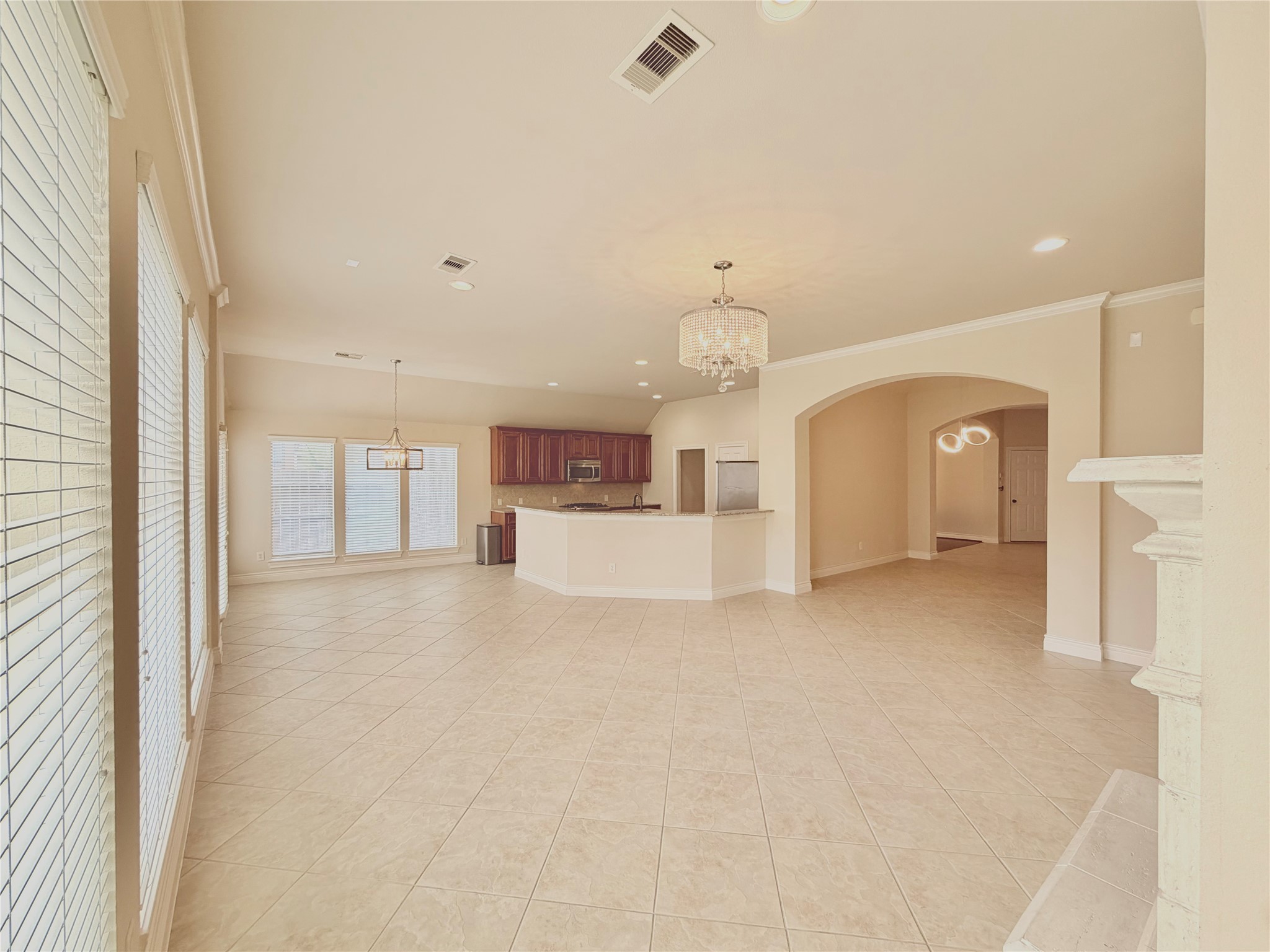 22015 Rustic Canyon Lane Richmond, TX 77469 - Photo 10 of 26 a view of a kitchen with a refrigerator and white cabinets