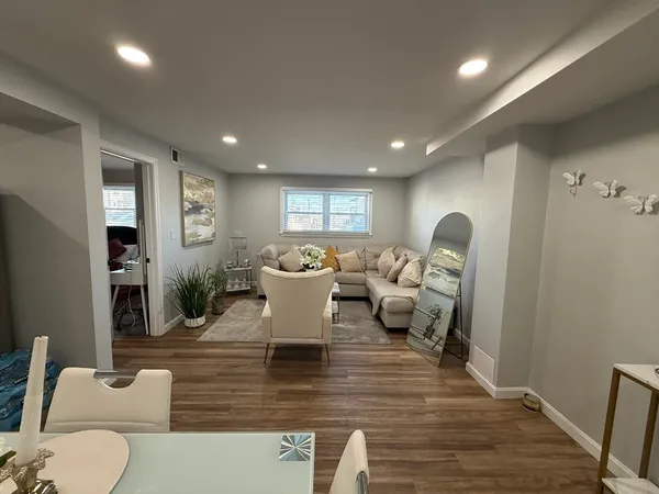 a living room with furniture a dining table and a potted plant
