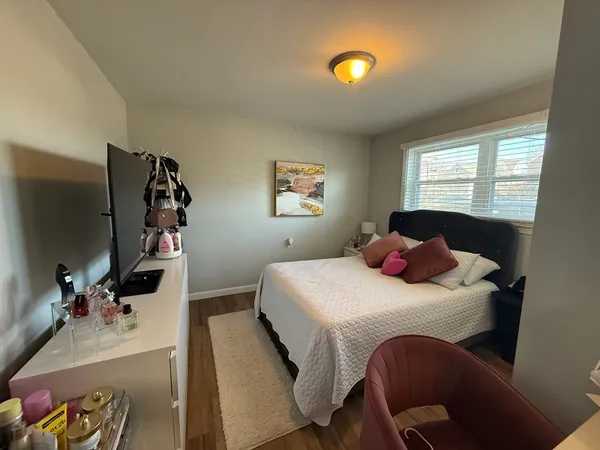 a bedroom with a bed and a dresser
