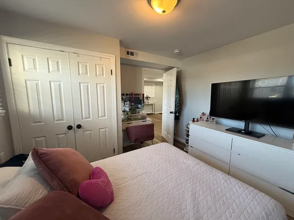 a bedroom with a bed and a flat screen tv