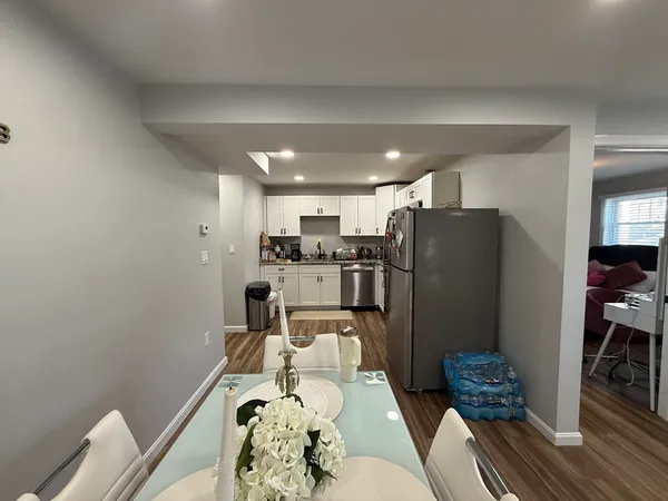 a kitchen with stainless steel appliances granite countertop a refrigerator and a stove top oven