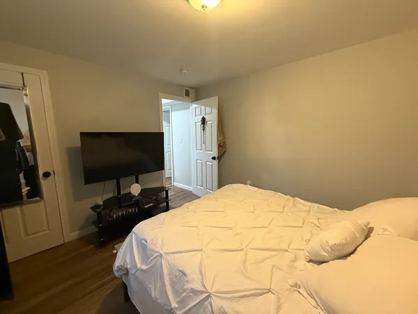 a bedroom with a bed and a flat screen tv