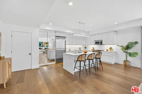 a view of a dining room kitchen with furniture and wooden floor
