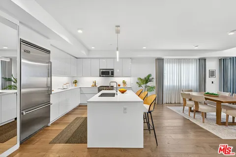 a view of kitchen with white cabinets