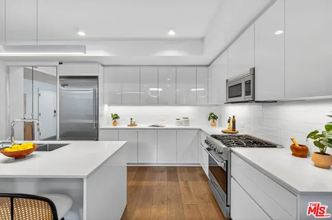 a kitchen with a sink a stove cabinets and counter space