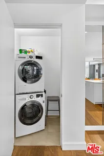 a view of a hallway with washer and dryer