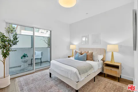 a bedroom with a bed and a lamp