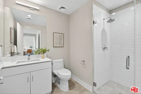 a bathroom with a toilet sink shower and mirror