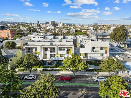 a view of a white building among the street with seating space