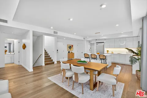 a dining room with furniture and wooden floor