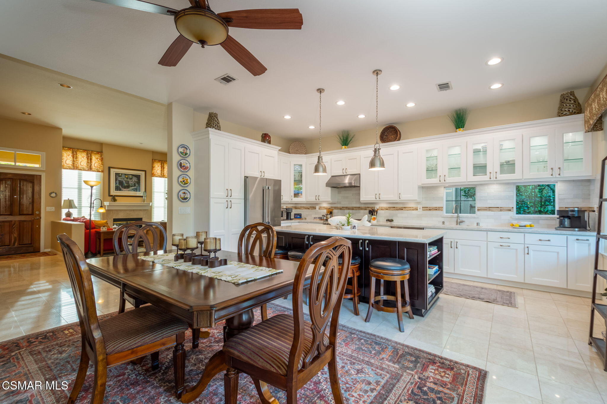 1126 Corte Riviera Camarillo, CA 93010 - Photo 14 of 36 a dining area with a table chairs and a kitchen view