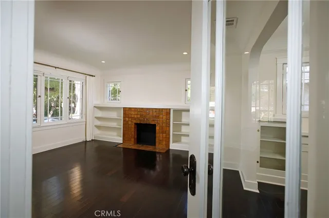 wooden floor in an empty room and a fireplace