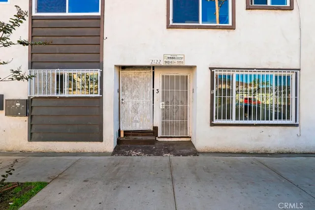 a view of an empty room with wooden floor and closet