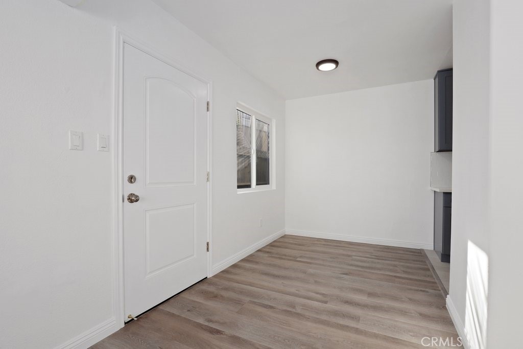 2122 East 10th Street Long Beach, CA 90804 - Photo 22 of 75 a view of an empty room with wooden floor and a window