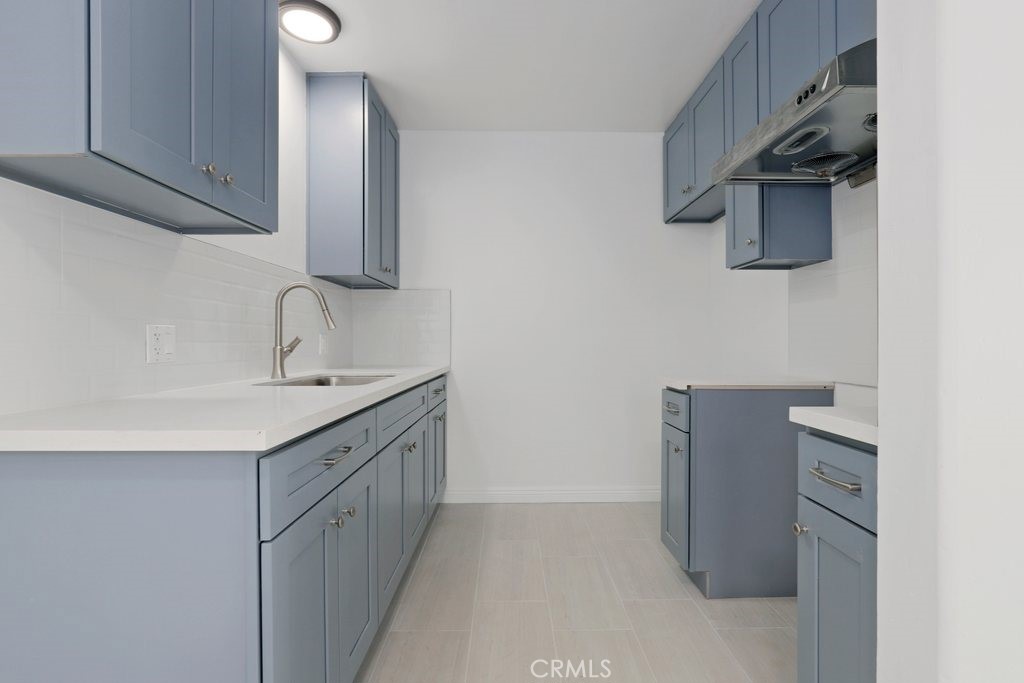 2122 East 10th Street Long Beach, CA 90804 - Photo 25 of 75 a kitchen with stainless steel appliances granite countertop a sink stove and refrigerator
