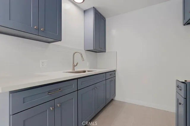 a kitchen with stainless steel appliances a refrigerator and a stove top oven