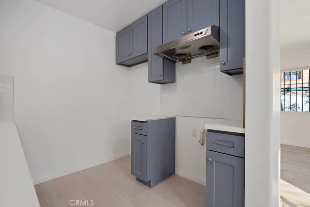 a kitchen with a sink cabinets and wooden floor