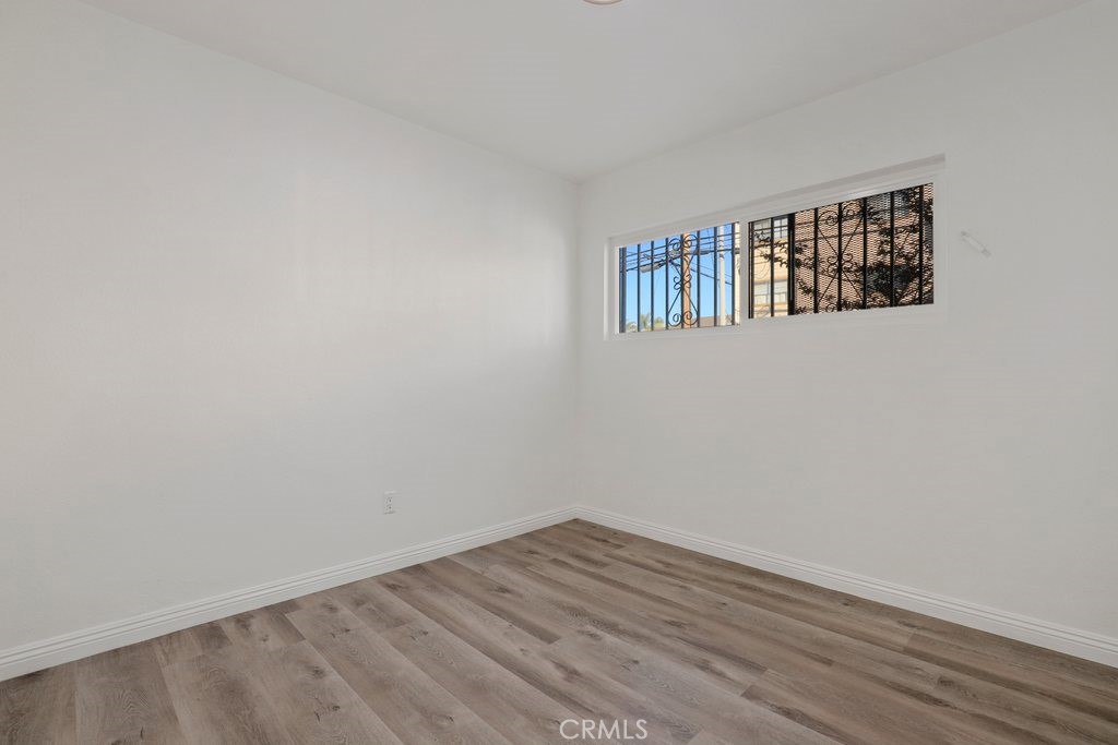 2122 East 10th Street Long Beach, CA 90804 - Photo 28 of 75 a view of an empty room with wooden floor and a window
