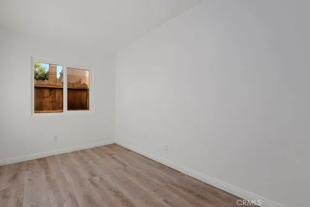 an aerial view of a residential houses with outdoor space and parking